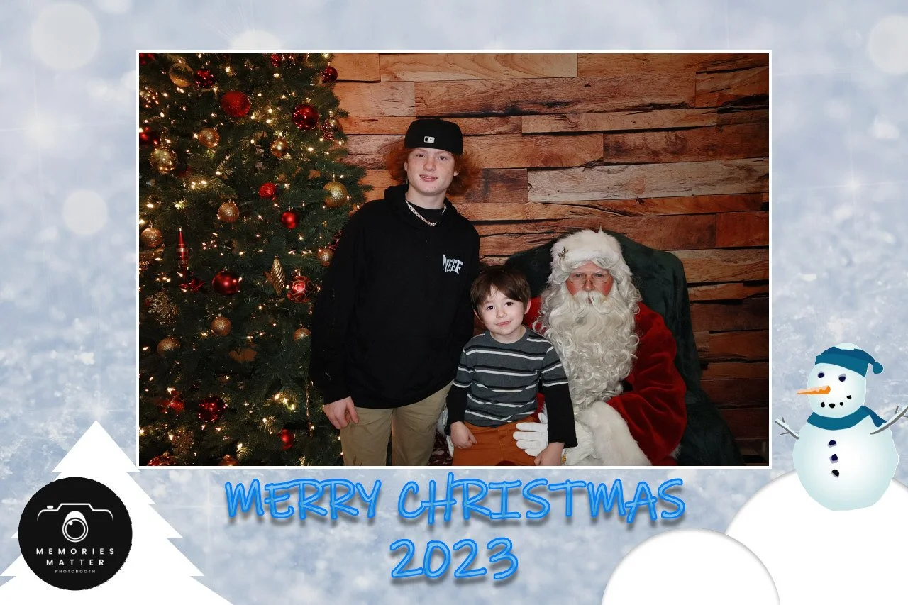 Kids and family smiling with Santa at the photobooth