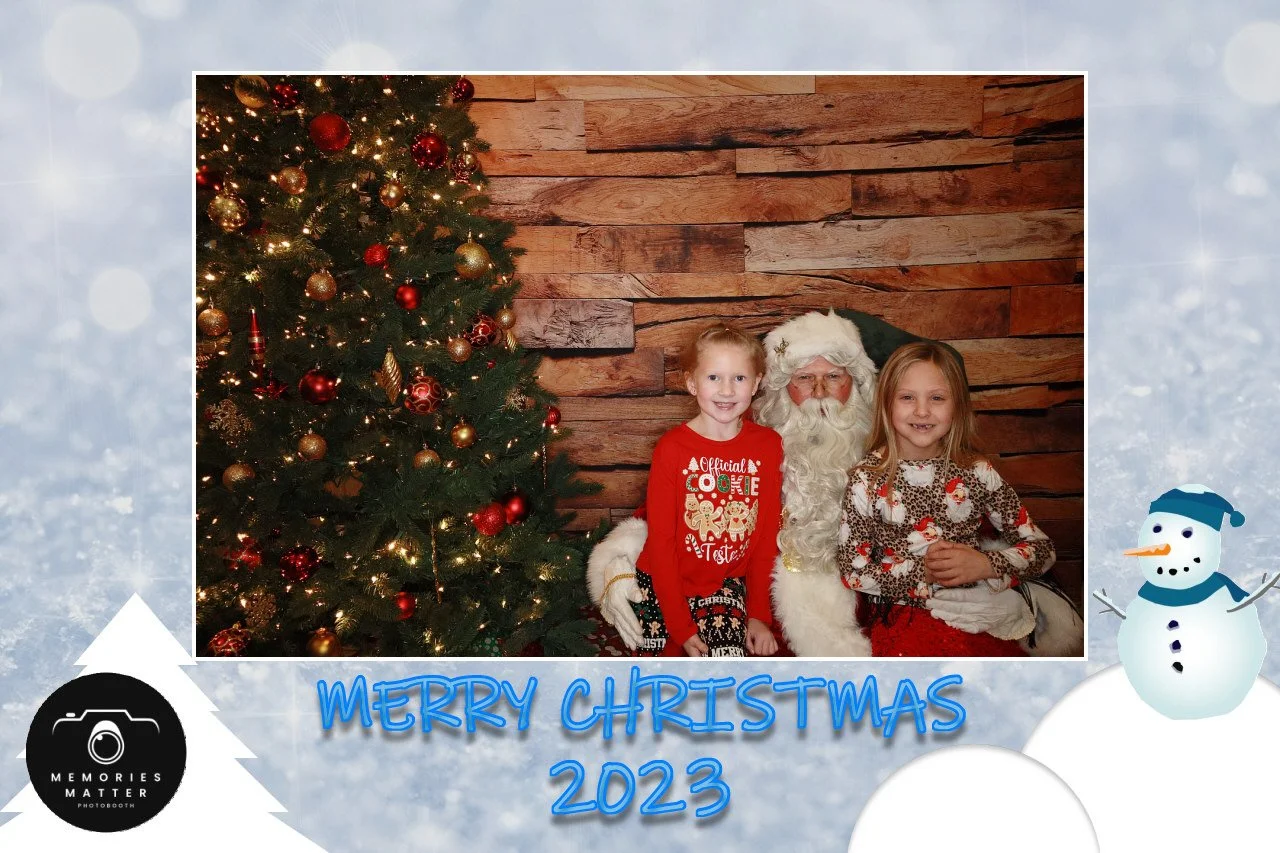 Guests posing at a festive holiday photobooth in Kingsport