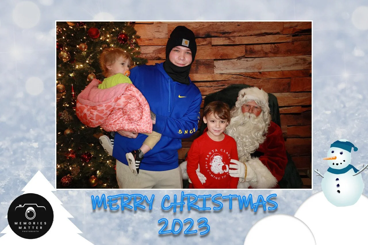 A family enjoying the Merry Christmas photobooth experience